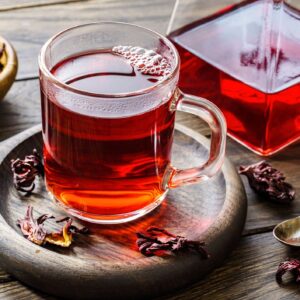 Cup of hot hibiscus tea on table