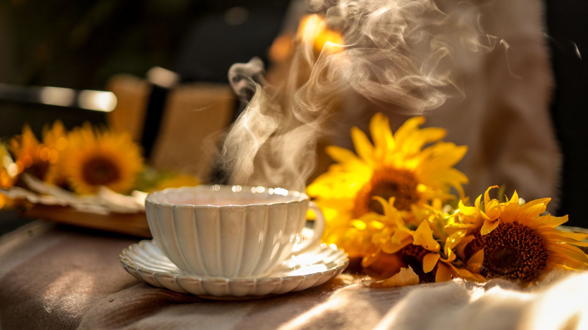 Steaming cup of tea in a cozy setting
